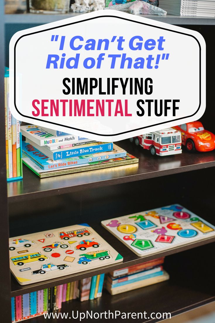 a book shelf filled with lots of books and toy cars next to a sign that says i can't get rid of that simlifying sentimental stuff