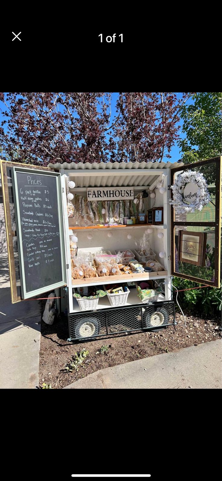 an old fashioned food cart is parked on the side of the road