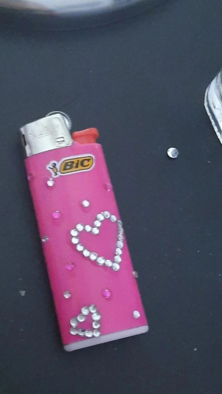 a lighter shaped like a heart on top of a table