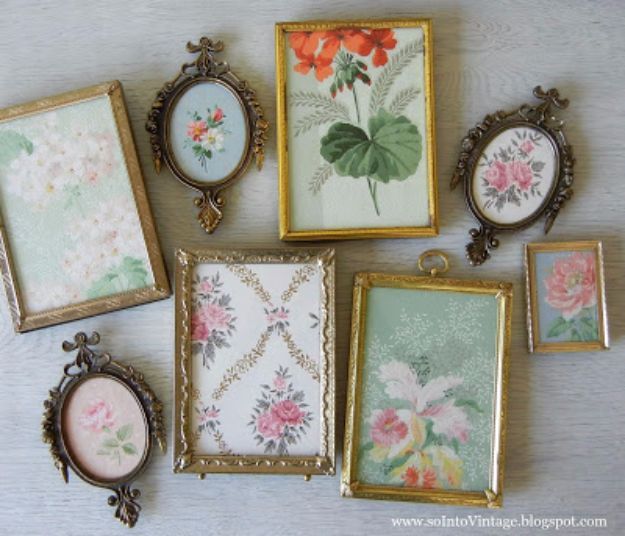 there are many different framed pictures on the table with flowers and leaves painted on them