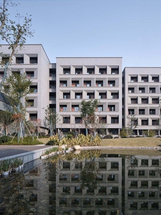 an apartment building next to a body of water