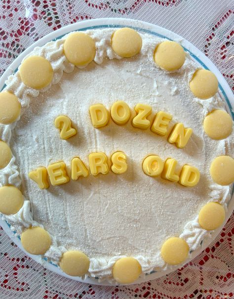 a cake with the words dozen ears old spelled in frosting and yellow icing