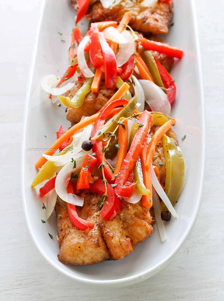 a white plate topped with chicken and veggies