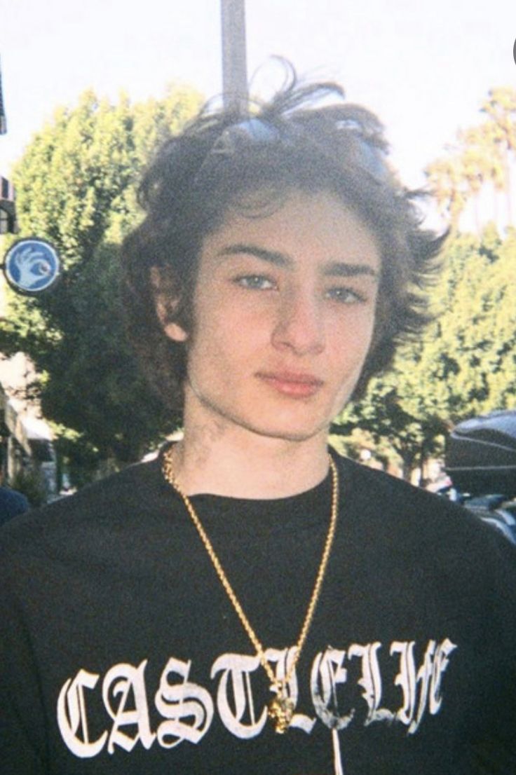 a young man wearing a black shirt with the word castle on it