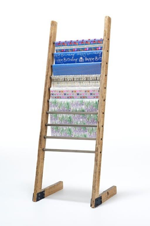 a wooden ladder with many different fabrics on it's sides and the bottom section