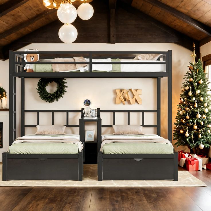 two beds in a room with christmas decorations on the wall and wooden flooring around them