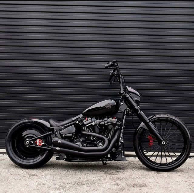 a black motorcycle parked in front of a garage door