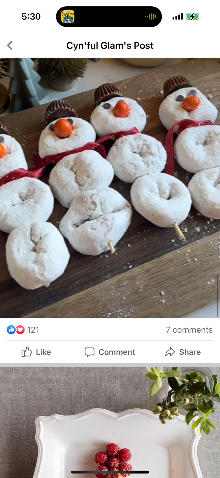 a plate with donuts shaped like snowmen on it, and another photo of them in the background