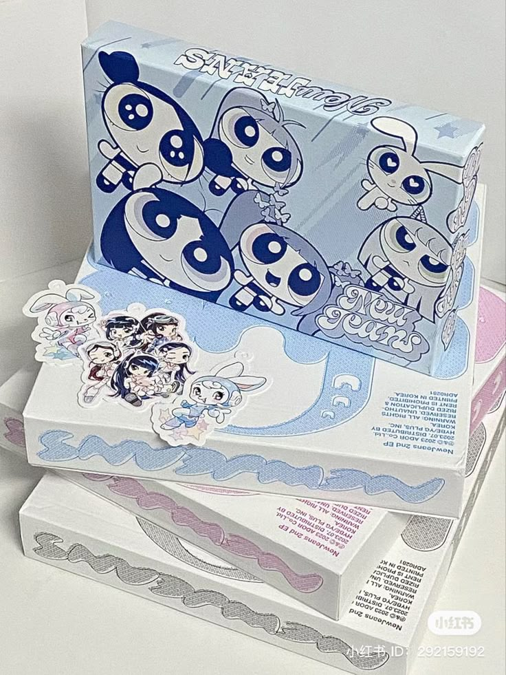 three boxes stacked on top of each other with cartoon stickers on the front and back