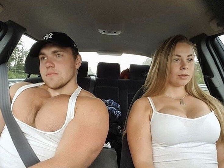 two people sitting in the back seat of a car