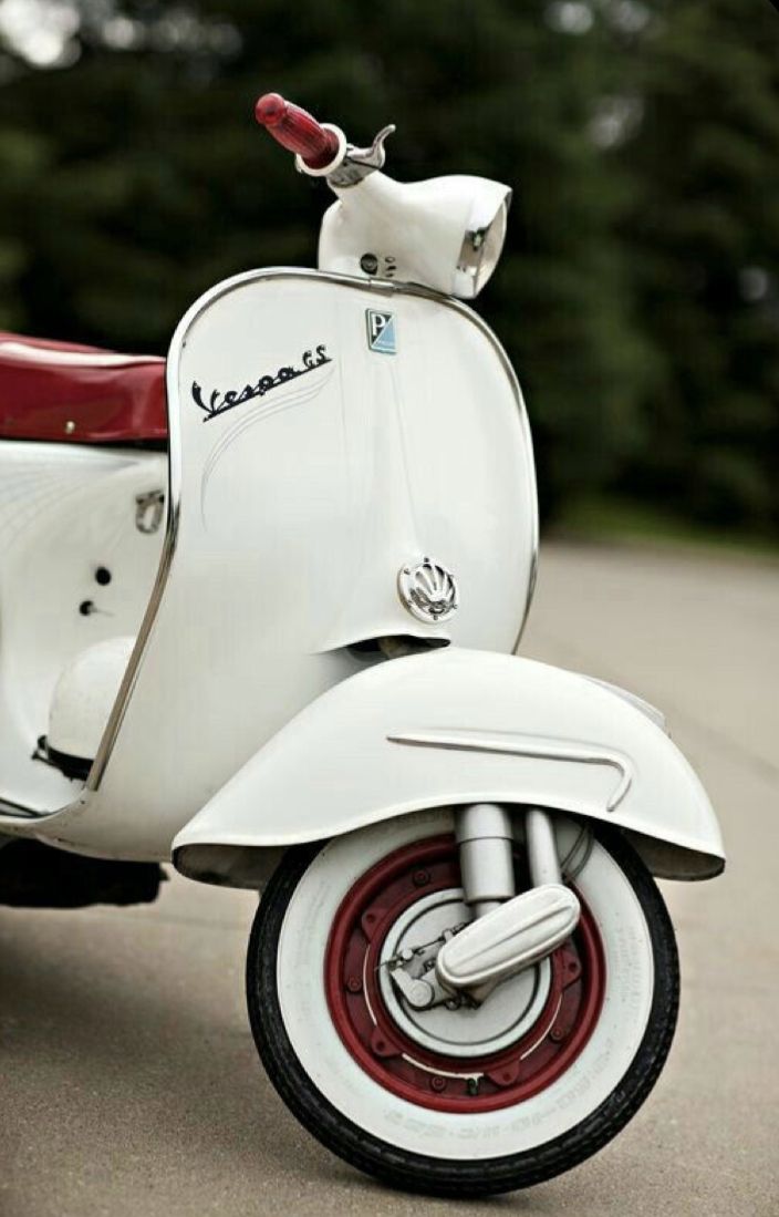 a white scooter is parked on the street