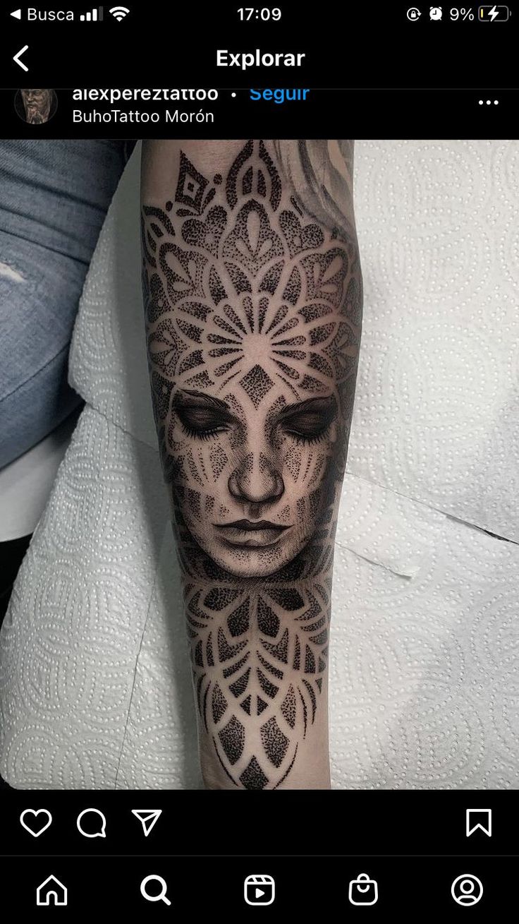 a person with a tattoo on their arm that has an image of a woman's face