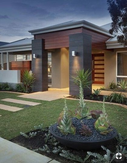 a modern house with landscaping in the front yard