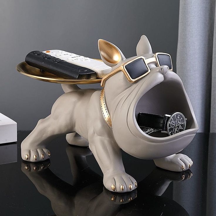 a dog figurine with sunglasses and a cell phone on it's back