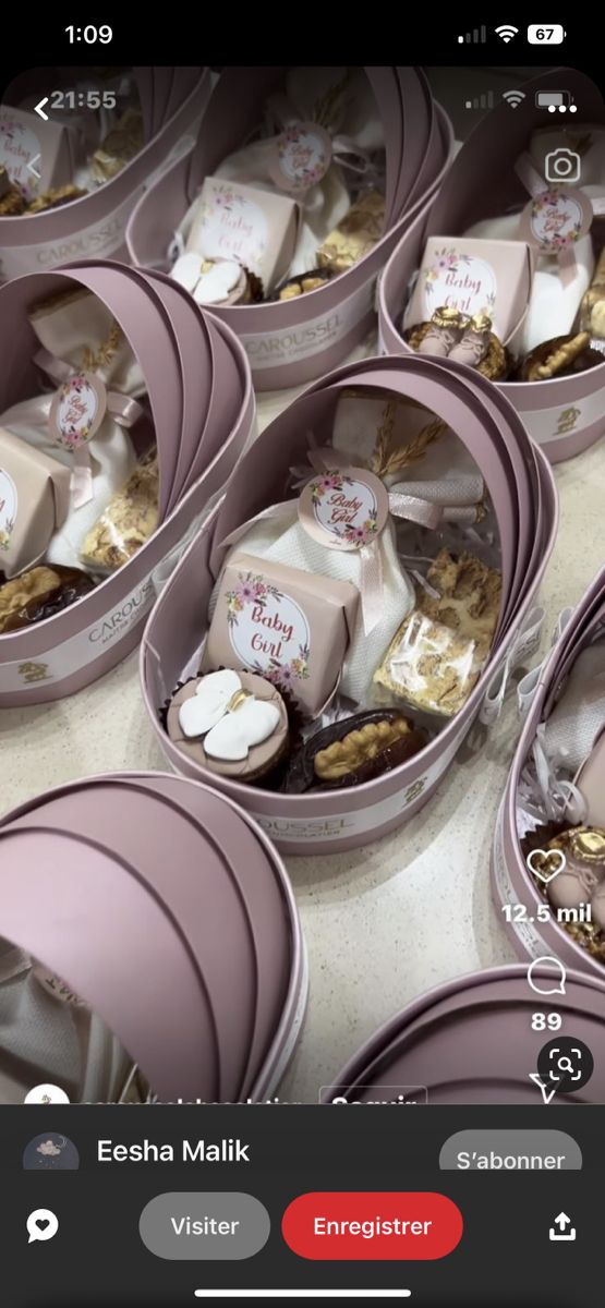 several pink containers filled with food on top of a table