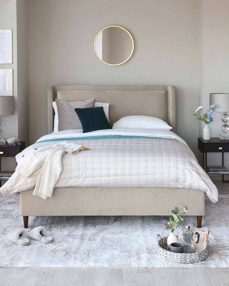 a bedroom with a large bed and white rugs on top of the carpeted floor