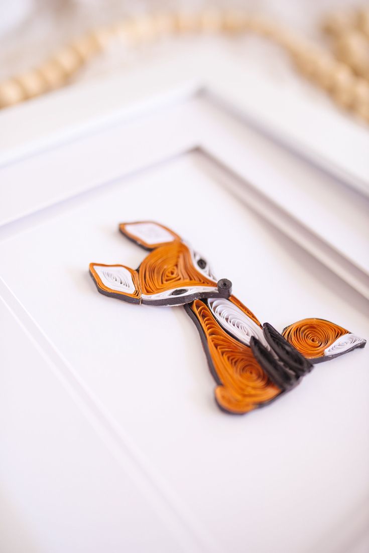 a pair of scissors sitting on top of a white table