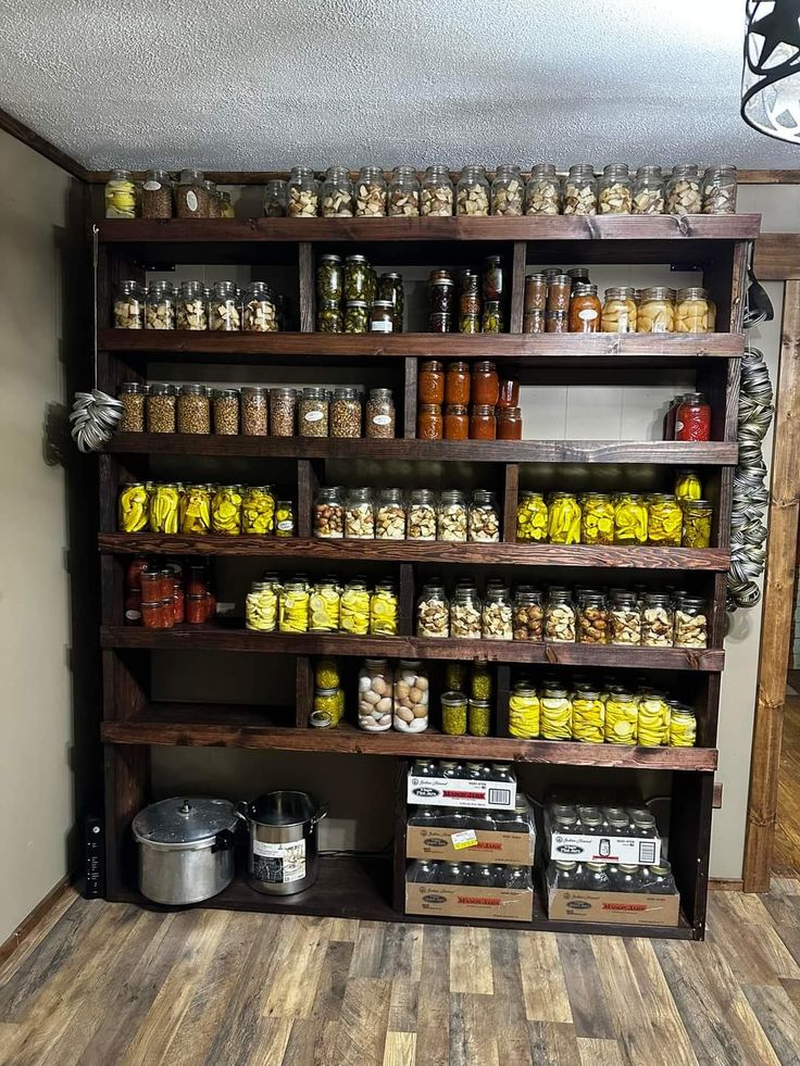 the shelves are filled with many different kinds of jars and food in containers on them