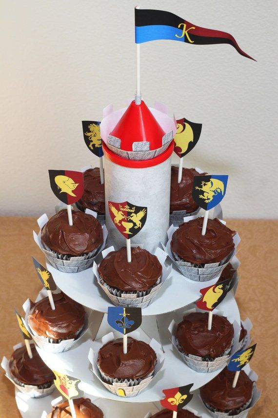 cupcakes are arranged on top of each other with flags sticking out of them