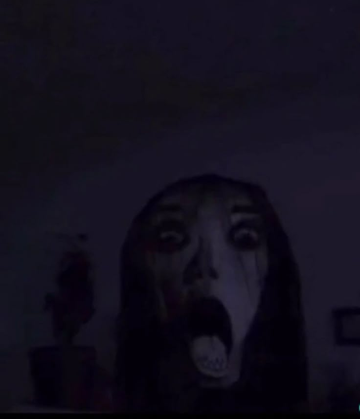 a woman with her mouth open in the dark