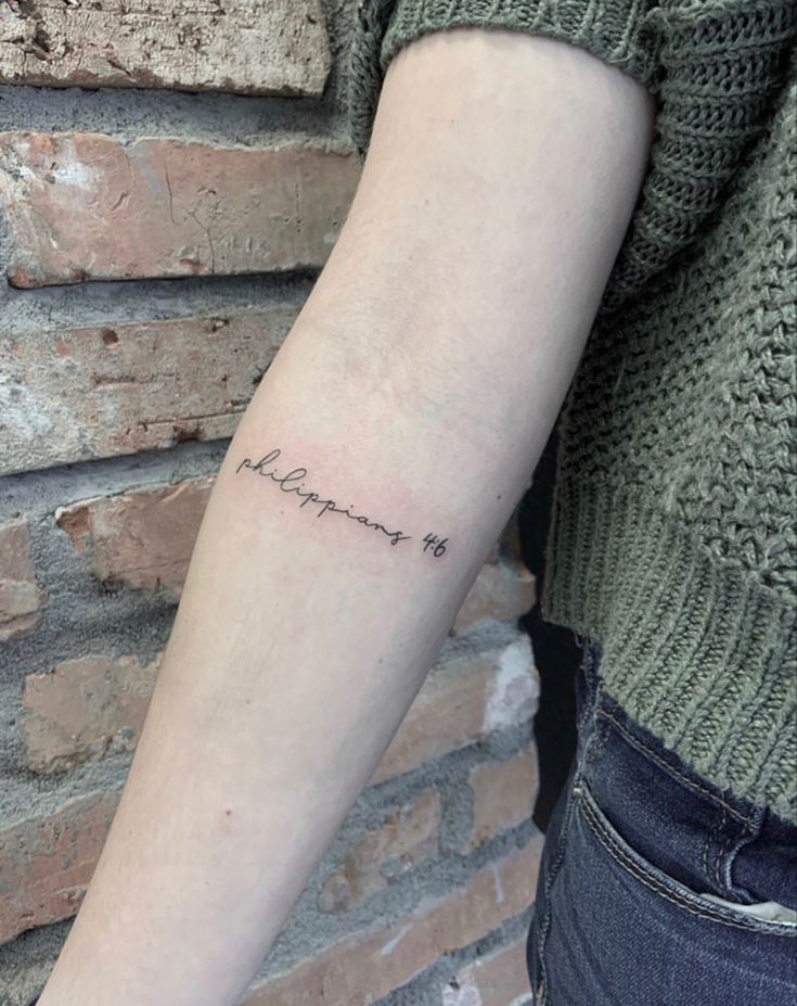 a person with a small tattoo on their arm