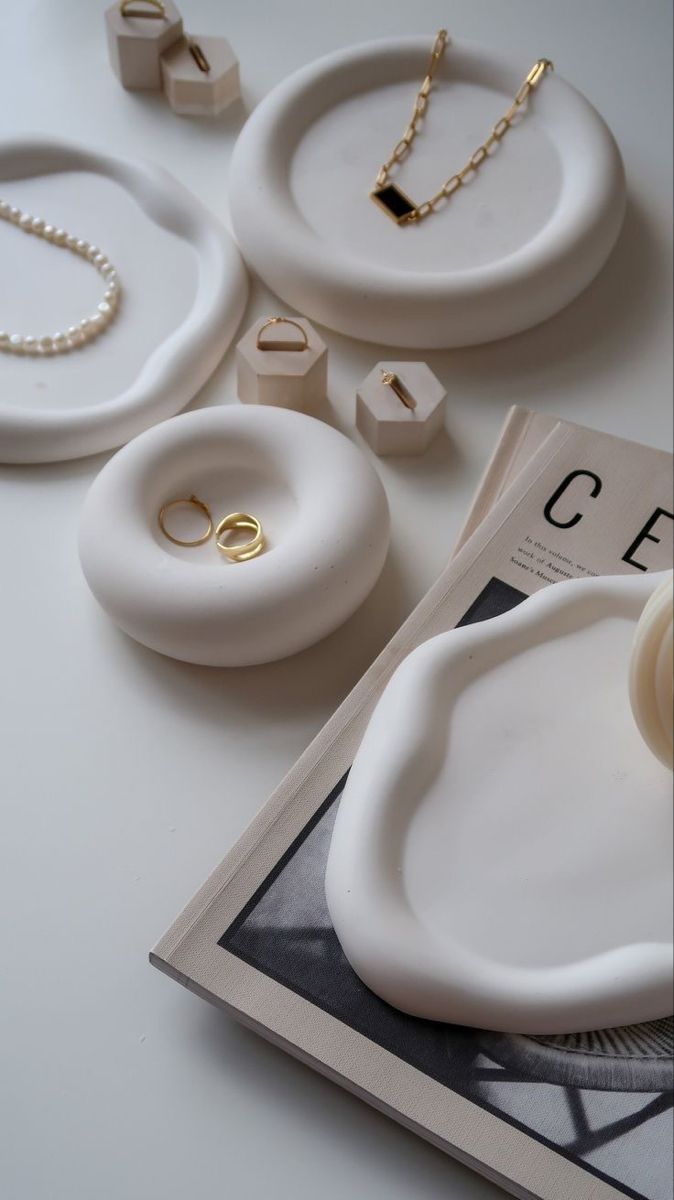 the table is covered with rings and other jewelry on it's side, including a ring dish