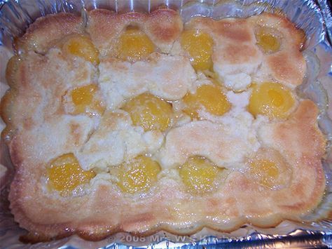 an uncooked pastry in a pan on top of tin foil with fruit toppings