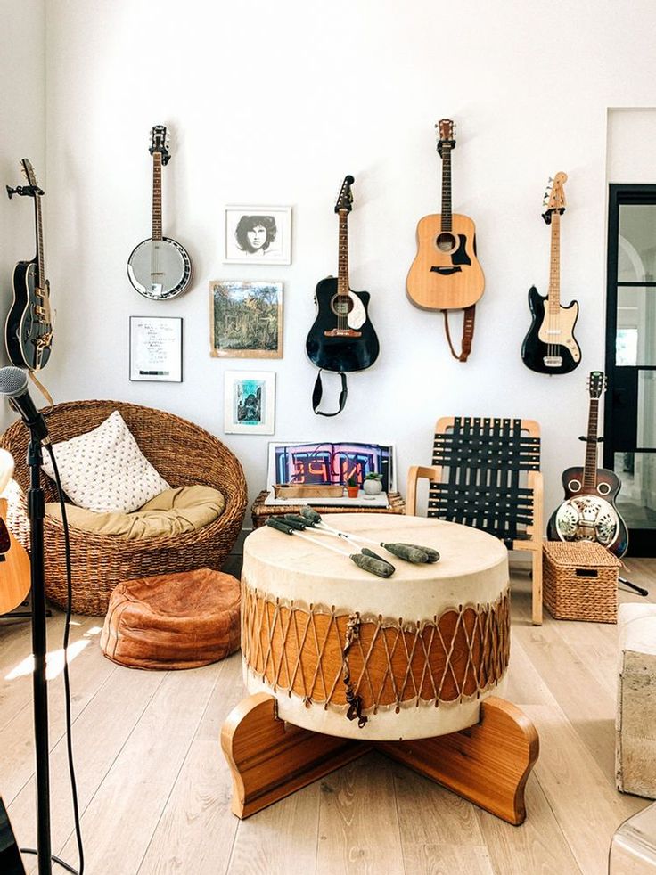 a living room with guitars on the wall and other musical instruments hanging from the walls