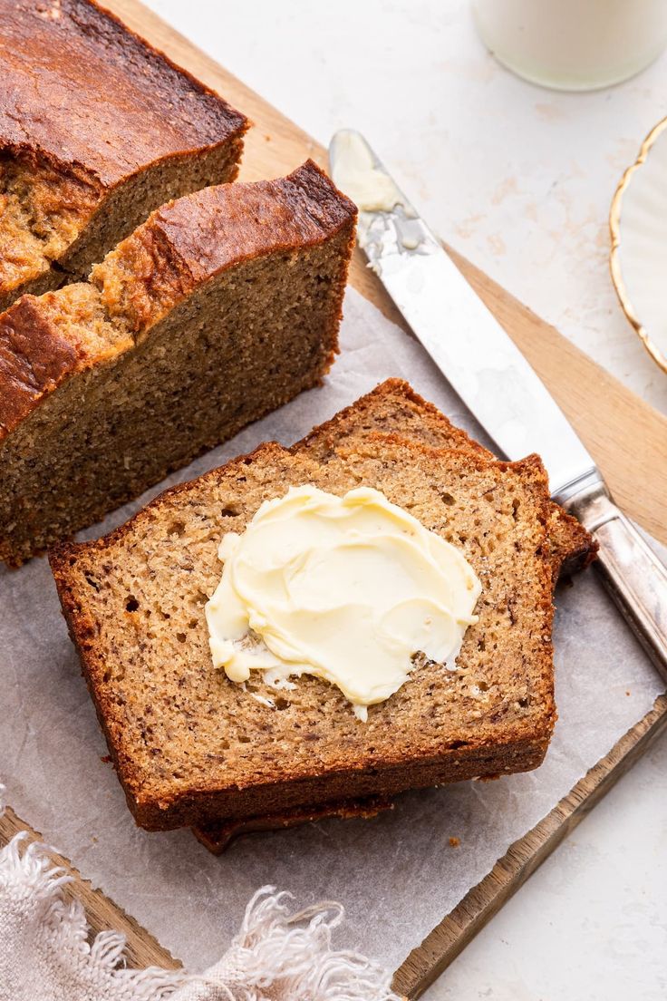 sliced loaf of banana bread with butter on top