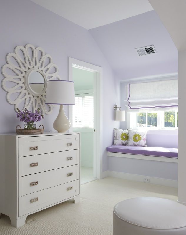 a white dresser sitting next to a window in a room with purple walls and furniture