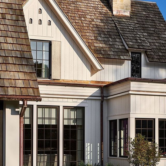 a white house with brown shingles and windows