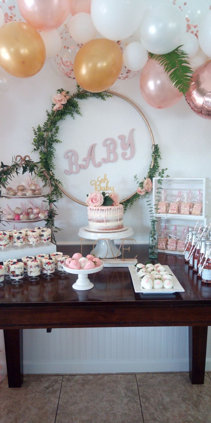 a baby shower party with cupcakes, cake and desserts on a table