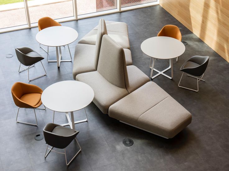 an overhead view of a couch, table and chairs in a room with large windows