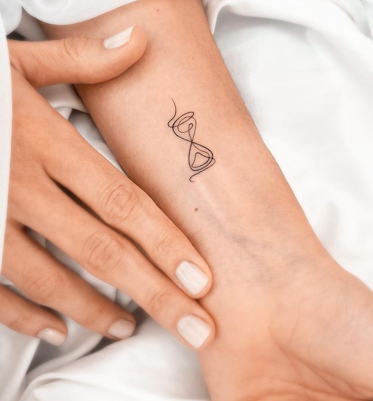 a woman's foot with a tattoo on her left arm and the word love written in it