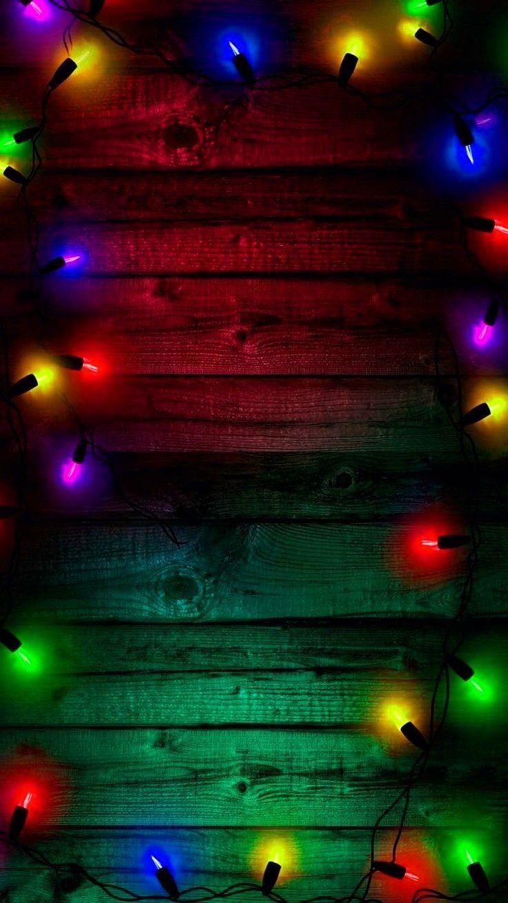 christmas lights on wooden planks with red, green and blue lights