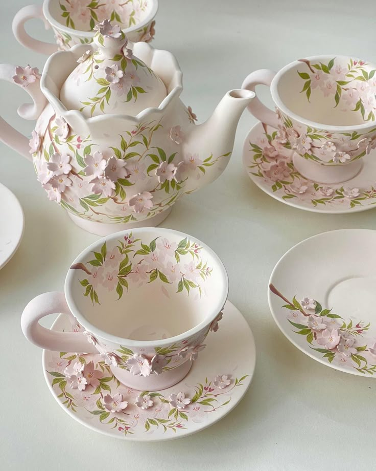 a tea set with pink flowers on it