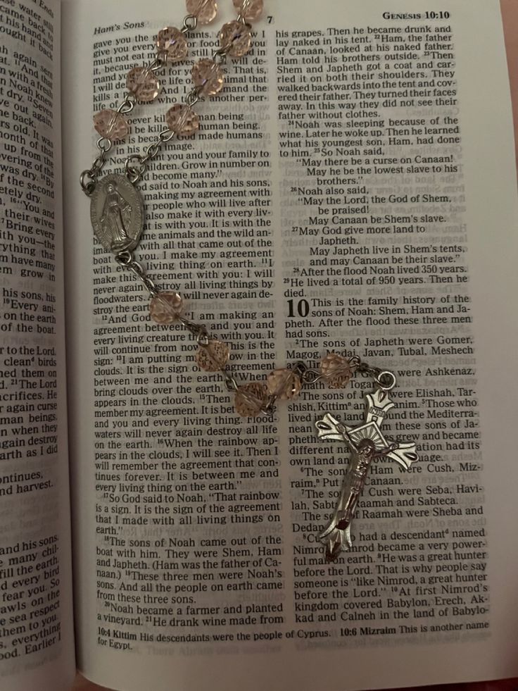 an open book with a rosary on it