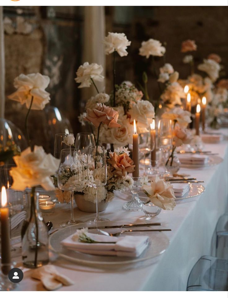 a long table is set with flowers and candles