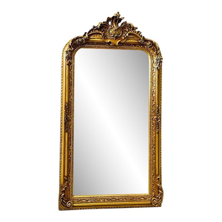 an ornate gold framed mirror against a white background