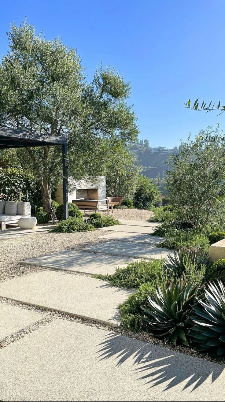 an outdoor patio with seating and trees in the background