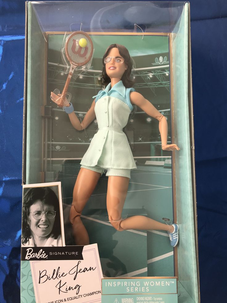 a barbie doll in a tennis outfit holding a racket