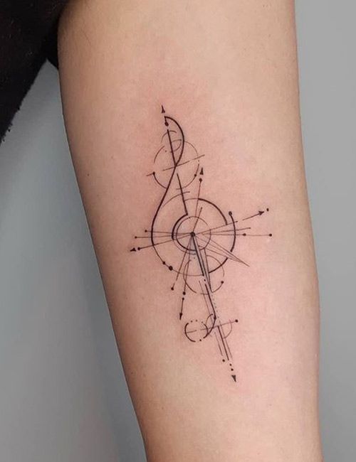 a tattoo on the leg of a woman with an arrow and musical notes in it