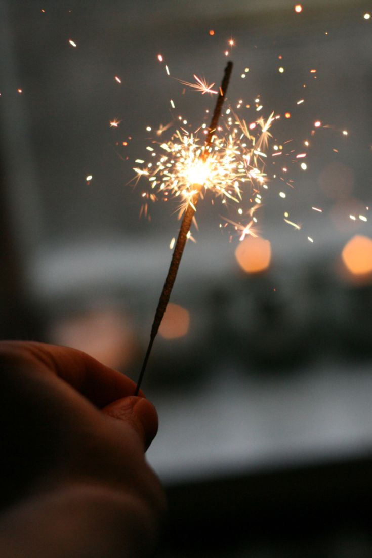 a person holding a sparkler in their hand