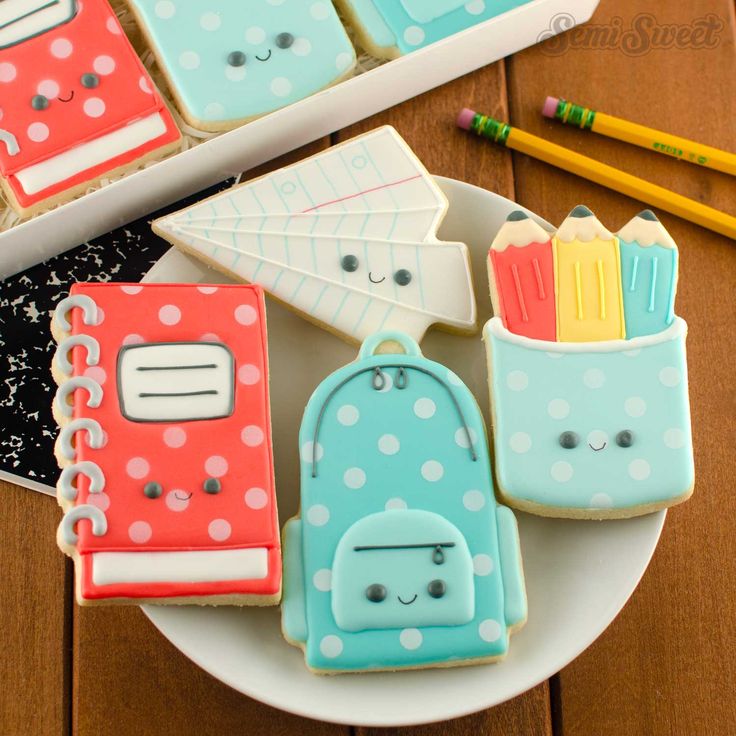 cookies decorated like school supplies on a plate