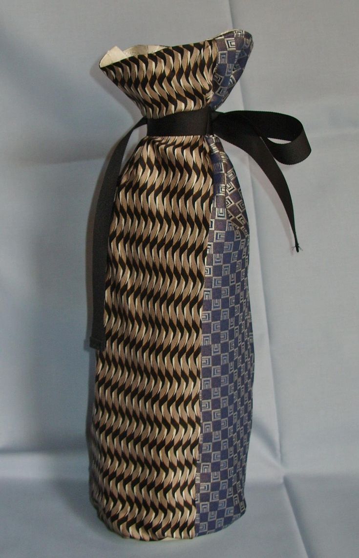 a bag made out of woven material with a black ribbon tied around the top and bottom