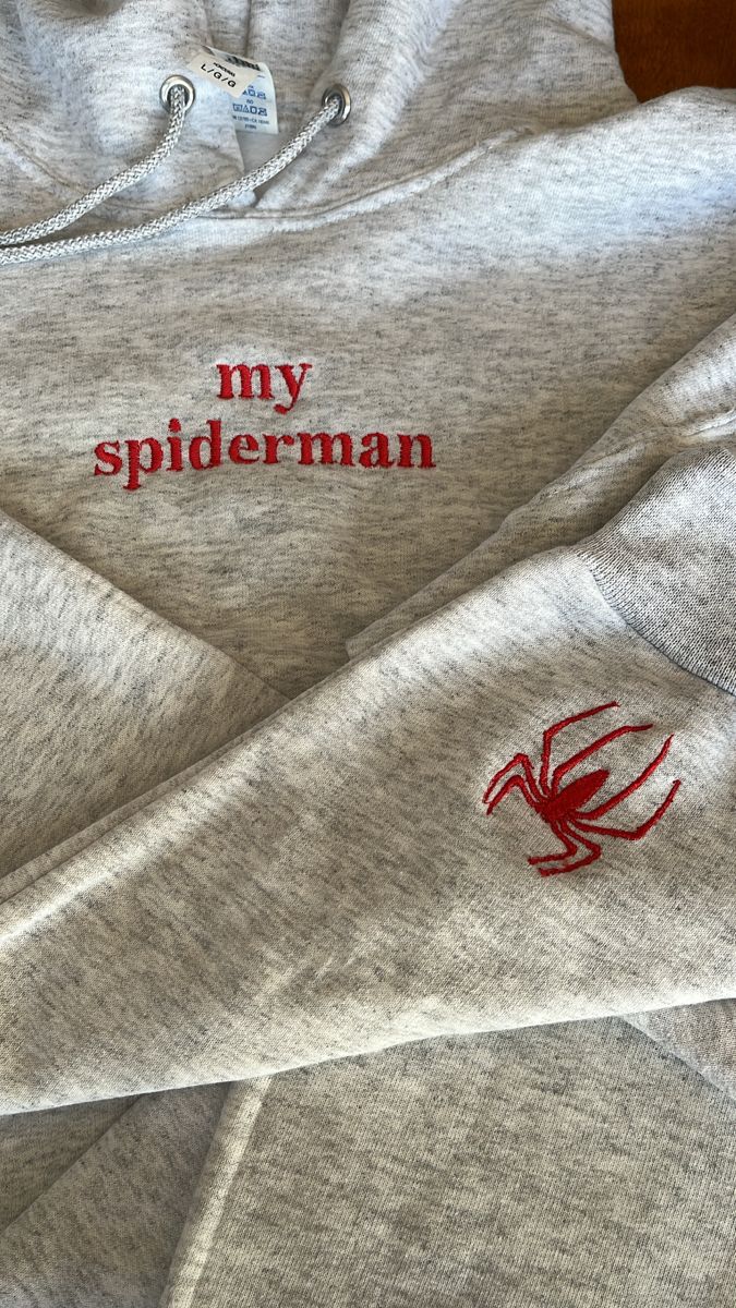 two sweatshirts with the words, my spiderman on them are laying next to each other