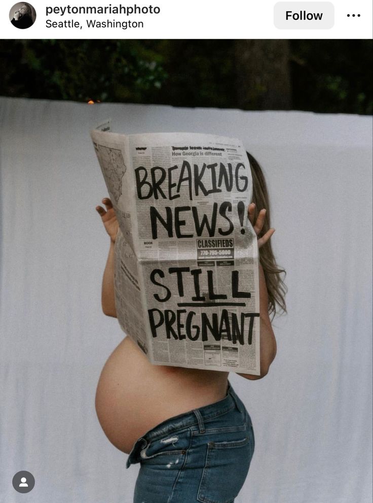 a pregnant woman reading a newspaper with the caption breaking news still pregnant