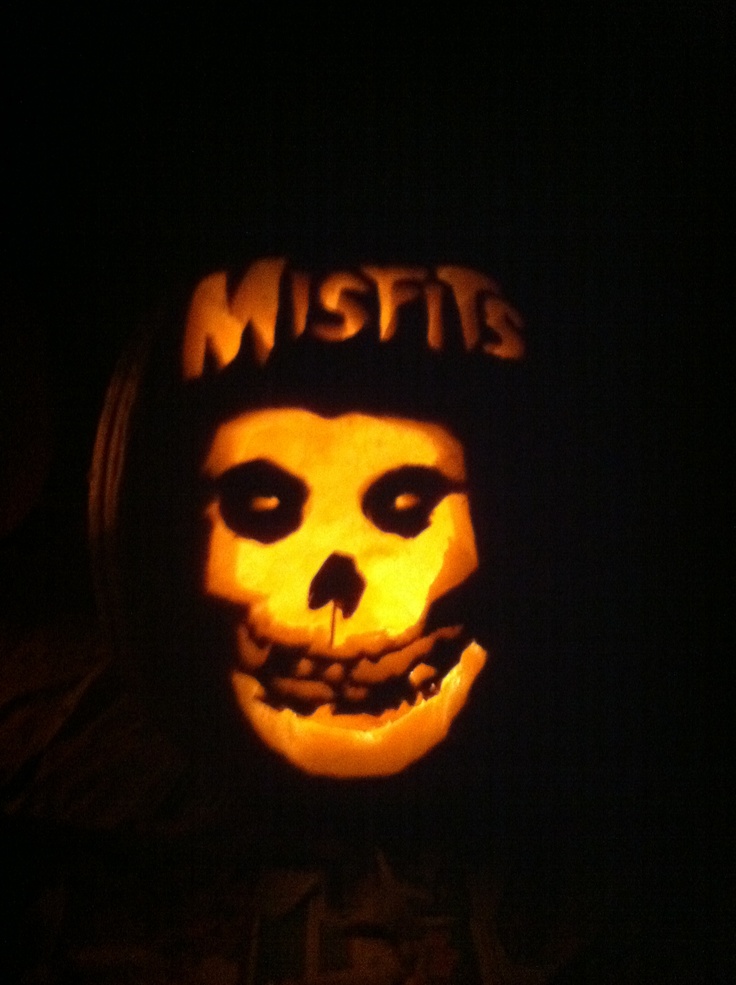 a pumpkin carved to look like a skeleton with the word mists on it's face