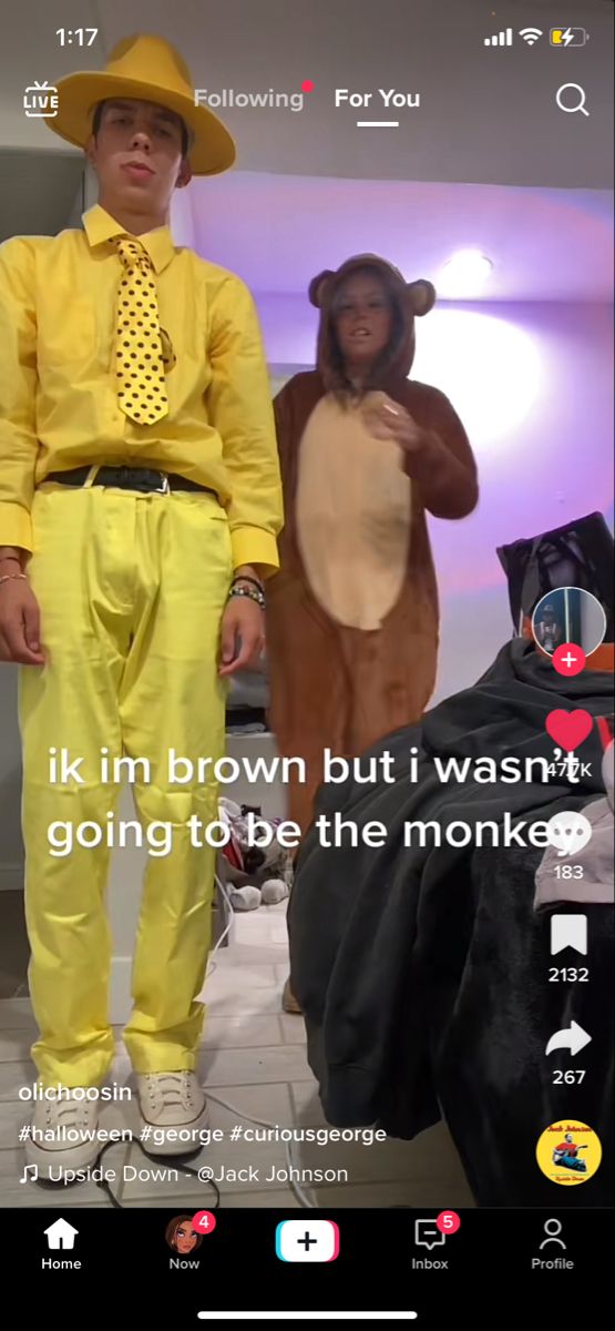 two people dressed in costumes standing next to each other and one person wearing a monkey costume