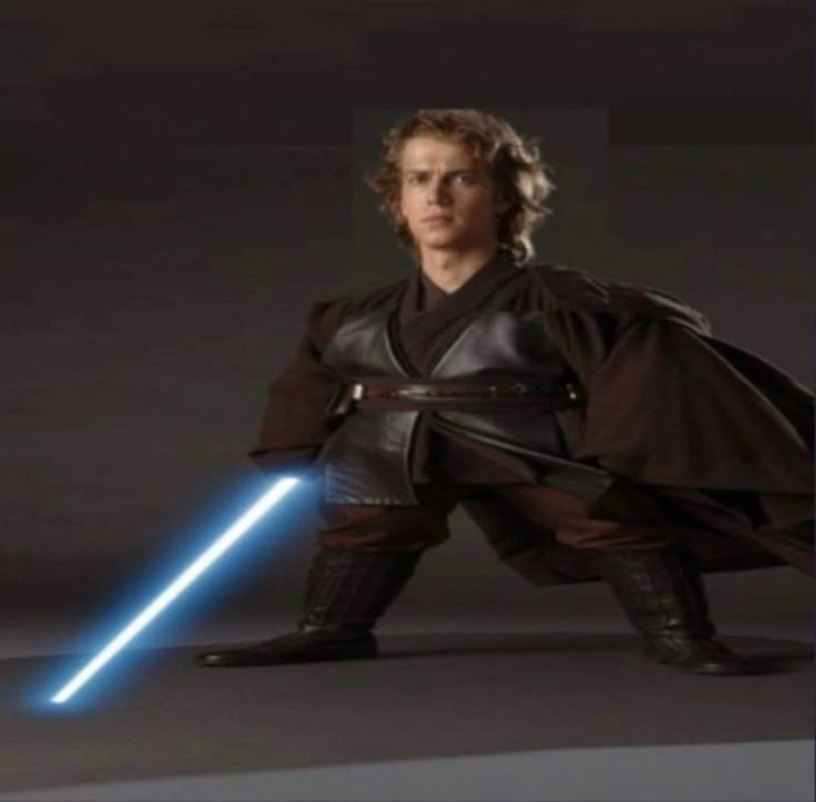 a man in a star wars costume holding a light saber